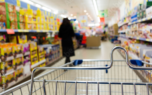 Photo: View from shopping cart trolley at supermarket shop. Retail. View from shopping cart trolley at supermarket shop. Retail.