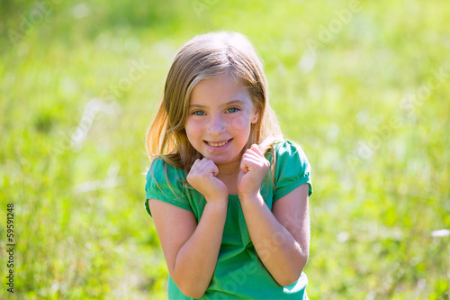 Photo: Blond kid girl excited gesture expression in green outdoor Blond kid girl excited gesture expression in green outdoor