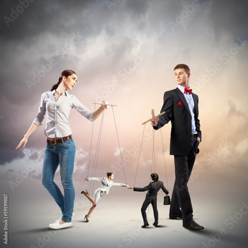 Photo: Businesspeople with marionettes Businesspeople with marionettes