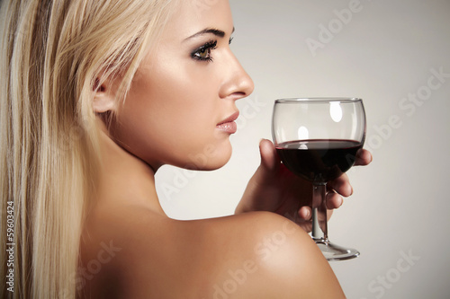 Photo: Beautiful Blond woman drinking red wine.naked beauty Beautiful Blond woman drinking red wine.naked beauty