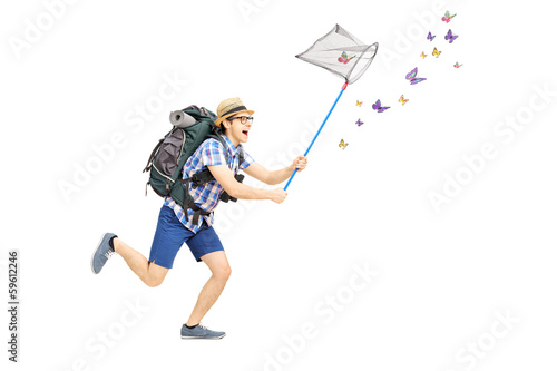 Photo: Full length portrait of a male tourist catching butterflies Full length portrait of a male tourist catching butterflies