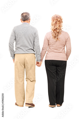 Photo: Full length portrait of a middle aged couple holding hands Full length portrait of a middle aged couple holding hands