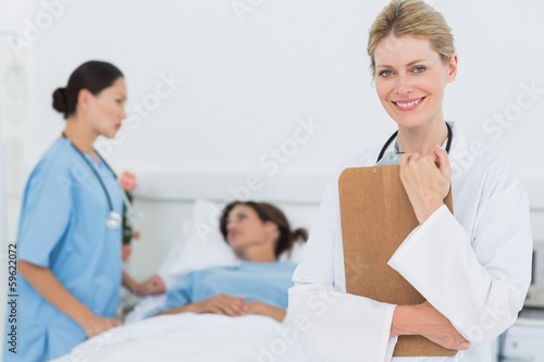 Photo: Smiling doctor with patient in hospital Smiling doctor with patient in hospital
