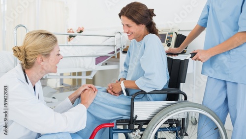 Photo: Doctor talking to patient in wheelchair at hospital Doctor talking to patient in wheelchair at hospital