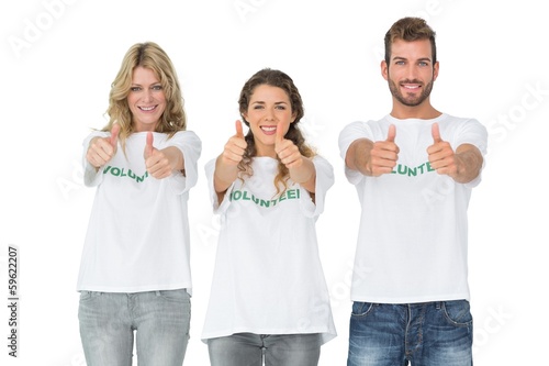 Photo: Portrait of happy three volunteers gesturing thumbs up Portrait of happy three volunteers gesturing thumbs up