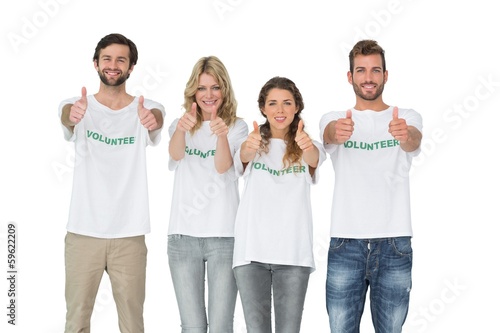 Photo: Group portrait of happy volunteers gesturing thumbs up Group portrait of happy volunteers gesturing thumbs up
