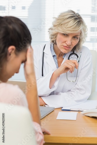 Photo: Female doctor listening to patient with concentration Female doctor listening to patient with concentration