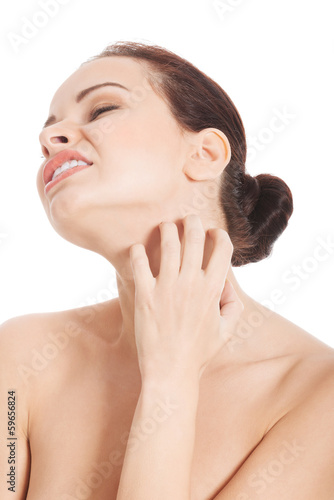 Photo: Young beautiful topless woman is scratching her neck. Young beautiful topless woman is scratching her neck.