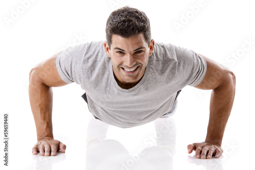 Photo: Handsome young man making pushups Handsome young man making pushups