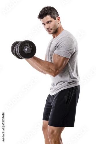 Photo: Athletic man lifting weights Athletic man lifting weights