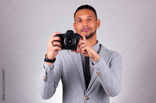 Photo: African american photographer holding a dslr camera - Black peop African american photographer holding a dslr camera - Black peop