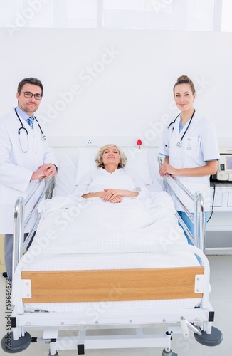 Photo: Doctors visiting a female patient in hospital Doctors visiting a female patient in hospital