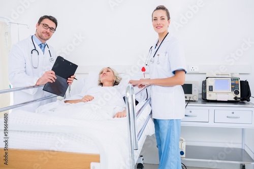 Photo: Doctors visiting a female patient in hospital Doctors visiting a female patient in hospital