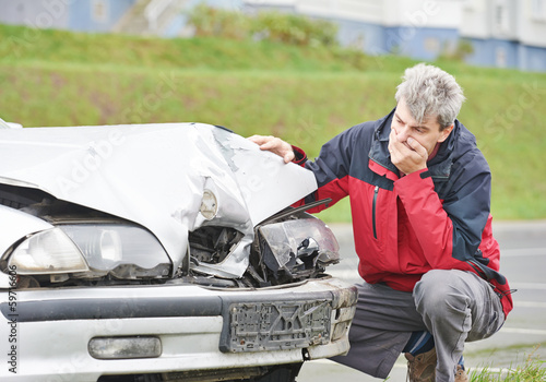 Photo: upset man after car crash upset man after car crash