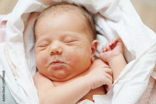 Photo: newborn baby in bedsheet newborn baby in bedsheet