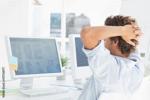 Photo: Casual young business man using computer Casual young business man using computer