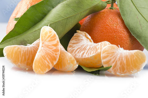 Photo: Orange mandarin or tangerine fruit with leaves Orange mandarin or tangerine fruit with leaves