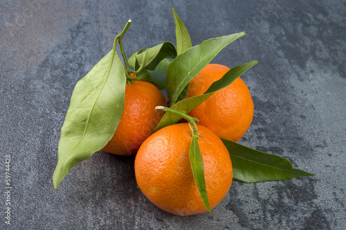 Photo: Orange mandarin or tangerine fruit with leaves Orange mandarin or tangerine fruit with leaves