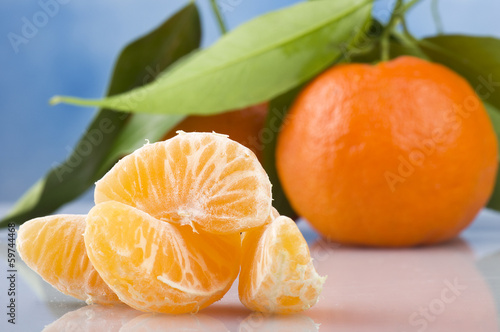 Photo: Orange mandarin or tangerine fruit with leaves Orange mandarin or tangerine fruit with leaves