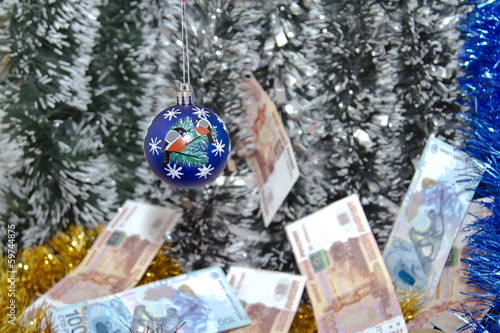 Photo: Christmas tinsel and banknotes of rubles. Christmas tinsel and banknotes of rubles.