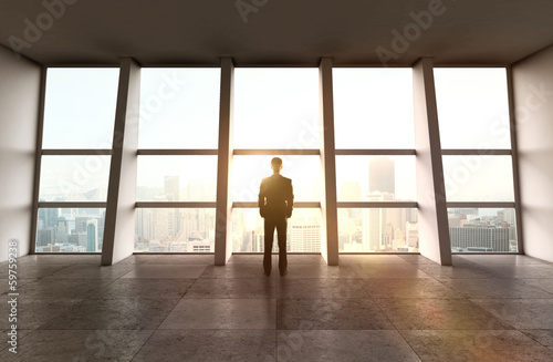 Photo: businessman standing in office businessman standing in office