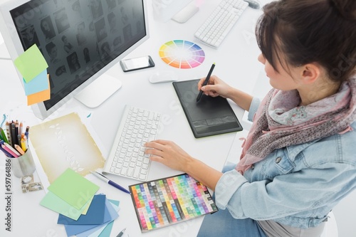 Photo: Artist drawing something on graphic tablet at office Artist drawing something on graphic tablet at office