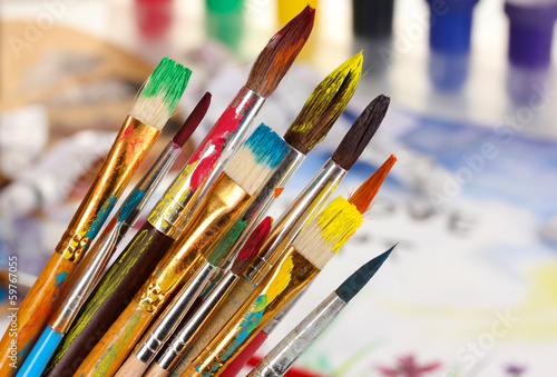 Photo: Many brush in paint on bright background Many brush in paint on bright background