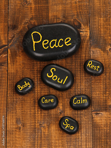 Photo: Spa stones on wooden background Spa stones on wooden background