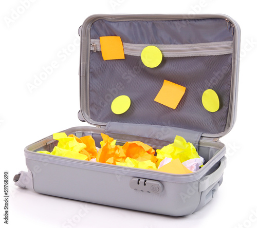 Photo: Open suitcase with paper stickers isolated on white Open suitcase with paper stickers isolated on white