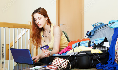 Photo: Girl reserving hotel or tickets online Girl reserving hotel or tickets online