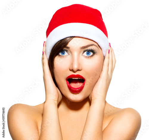 Photo: New Year Woman. Beauty Christmas Model Girl in Santa Hat New Year Woman. Beauty Christmas Model Girl in Santa Hat