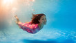 Underwater woman portrait wearing pink dress in swimming pool. Underwater woman portrait wearing pink dress in swimming pool.