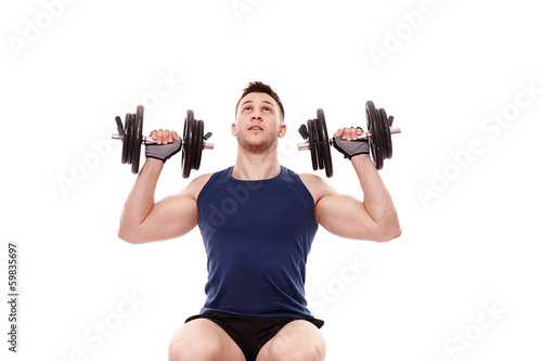 Photo: Young man working with dumbbells Young man working with dumbbells