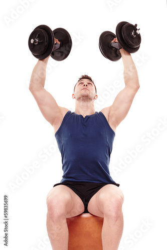 Photo: Young man working with dumbbells Young man working with dumbbells
