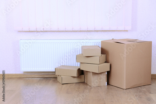 Photo: Empty room with stack of cartons: moving house concept Empty room with stack of cartons: moving house concept