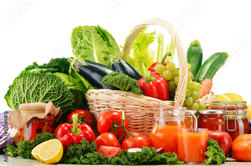Photo: Wicker basket with assorted organic vegetables and fruits isola Wicker basket with assorted organic vegetables and fruits isola