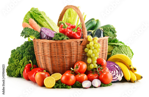 Photo: Wicker basket with assorted organic vegetables and fruits isola Wicker basket with assorted organic vegetables and fruits isola