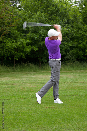 Photo: Golfer playing a mid iron shot Golfer playing a mid iron shot