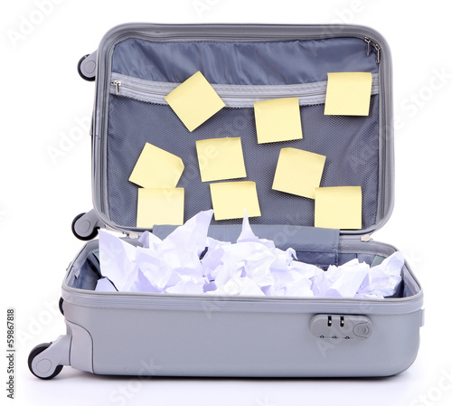 Photo: Open suitcase with paper stickers isolated on white Open suitcase with paper stickers isolated on white