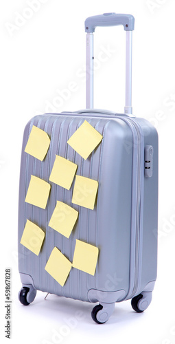 Photo: Suitcase with paper stickers isolated on white Suitcase with paper stickers isolated on white