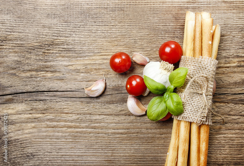 Photo: Traditional italian breadsticks on wooden background. Top view, Traditional italian breadsticks on wooden background. Top view,