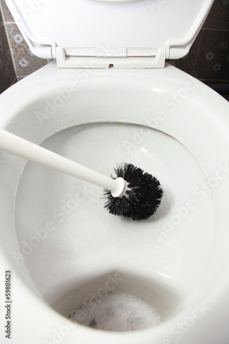 Photo: cleaning a toilet bowl with brush cleaning a toilet bowl with brush