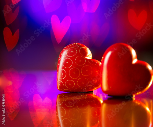 Photo: Couple of Valentines Red Hearts over Abstract Purple Background Couple of Valentines Red Hearts over Abstract Purple Background