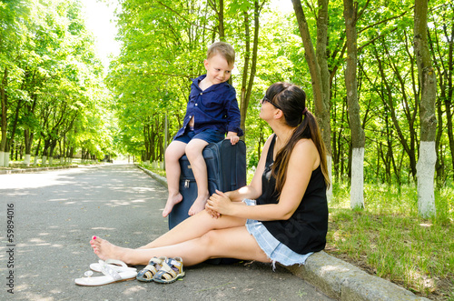 Photo: Mother and her little son waiting for a lift Mother and her little son waiting for a lift