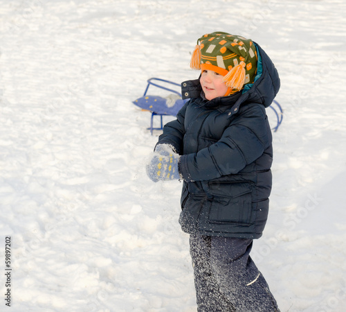 Photo: Little boy playing in the snow Little boy playing in the snow