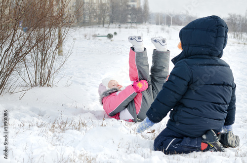 Photo: Two small children frolicking in the snow Two small children frolicking in the snow