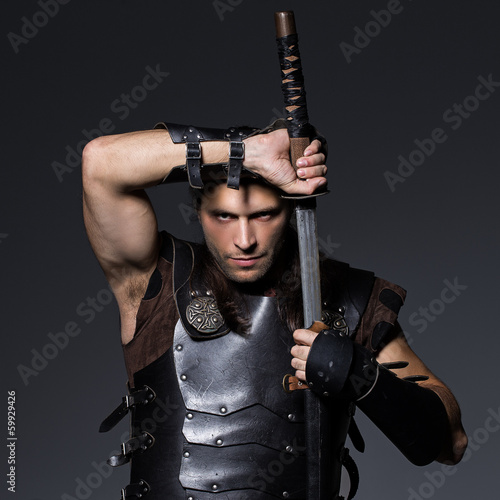 Photo: Young man with sword and historical costume Young man with sword and historical costume