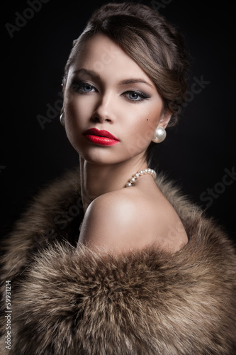 Photo: Vintage, retro. Beautiful, attractive woman wearing fur Vintage, retro. Beautiful, attractive woman wearing fur