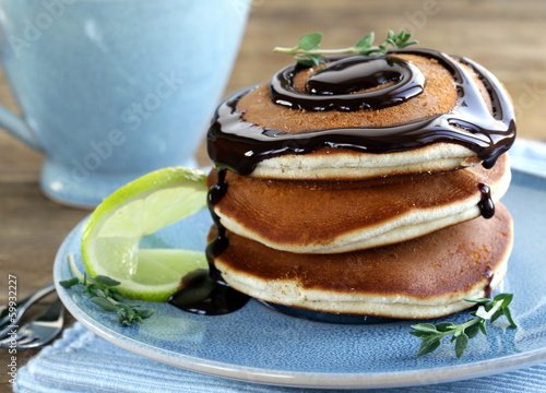 Photo: homemade pancakes with chocolate syrup and thyme homemade pancakes with chocolate syrup and thyme