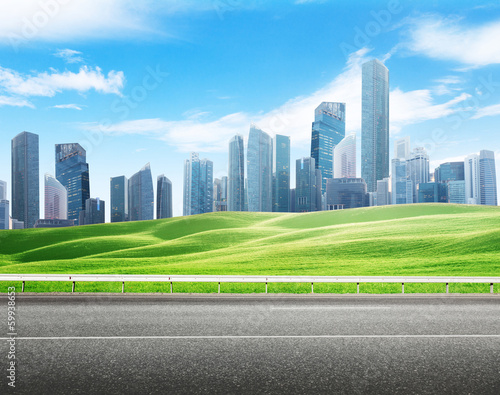 Photo: Asphalt road and modern city Asphalt road and modern city